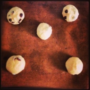 Dough split into 12 and rolled into small rolls, with the fruit added. Yum!